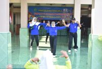 Ketua KOM Desa Tenggulunan Churriyah (kaos biru, depan) memimpin masyarakat berolahrga.